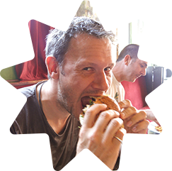 Daniel tucking into a burger that is clearly too big for him