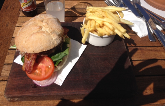One of the burgers with bacon in and fries served on a wooden slab (I do not get this craze)